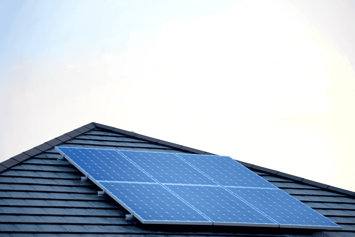 sun-hitting-solar-panel-on-house